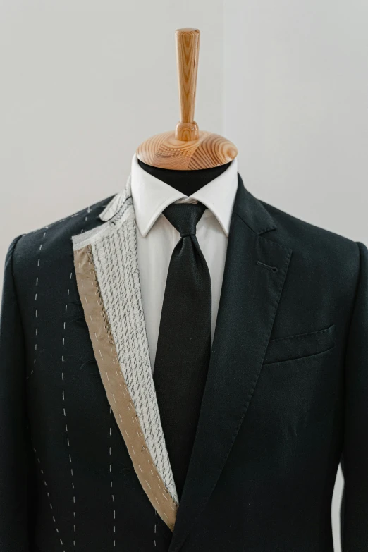 a close up of a suit on a mannequin, inspired by Pedro Álvarez Castelló, cut out, transforming, wearing a black suit, multi-part