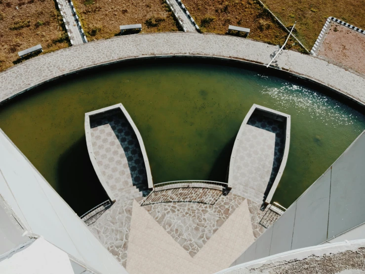 a bird's eye view of a body of water, inspired by Tadao Ando, pexels contest winner, brutalism, watertank, thumbnail, water wheel, pools