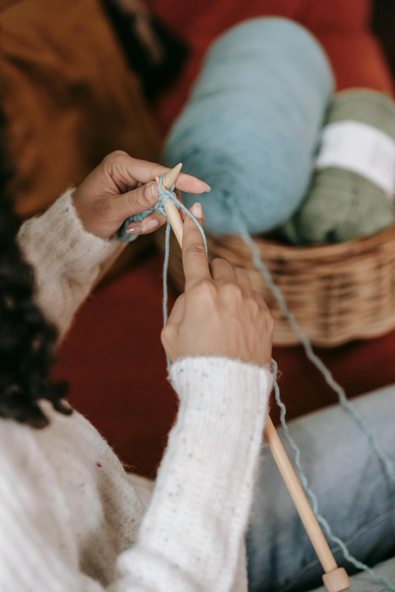 a woman knitting while sitting on a couch, trending on pexels, arts and crafts movement, blue, made of wool, a wooden, schools