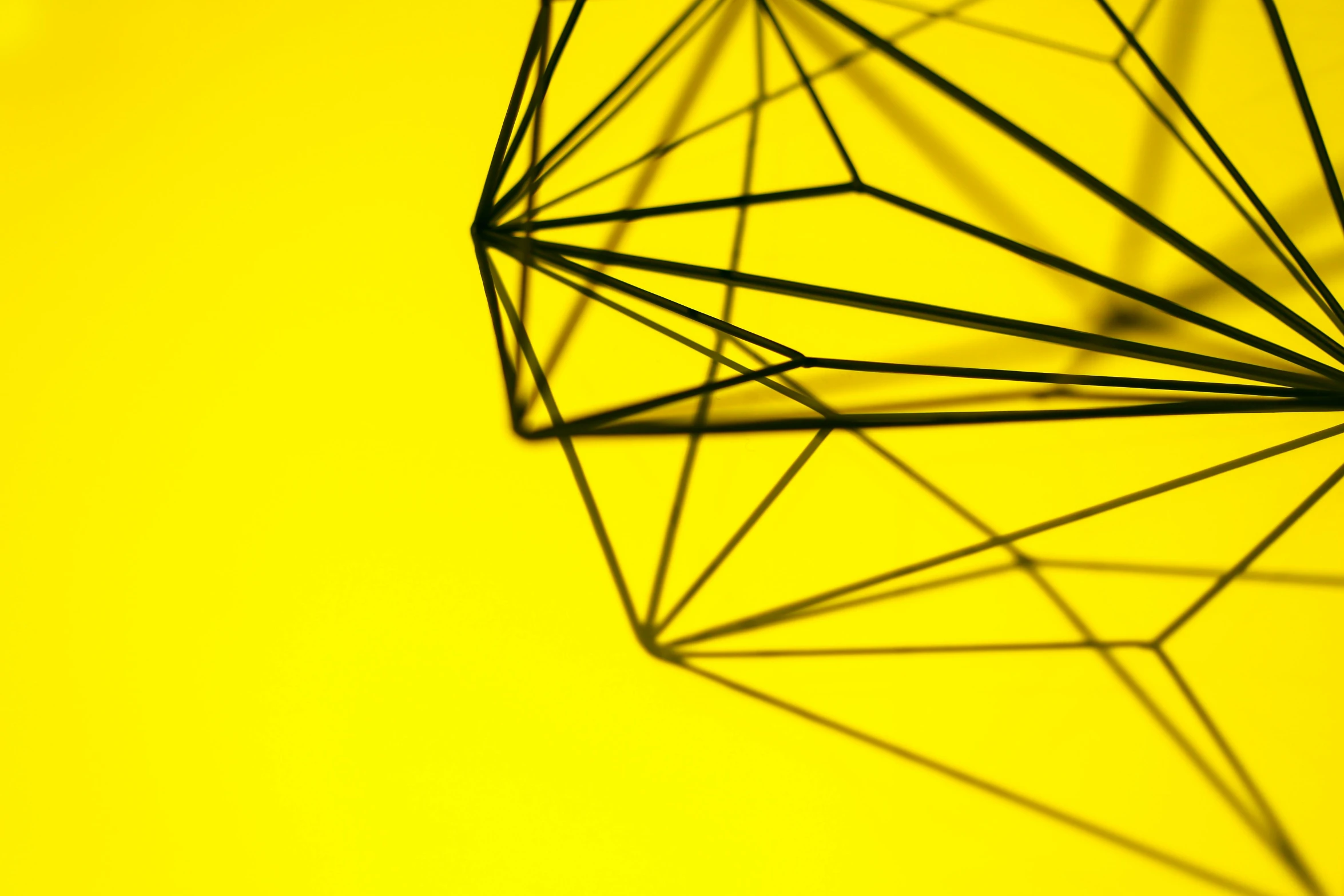 a close up of a geometric object on a yellow background, by Matija Jama, pexels, bright thin wires, geometrically realistic, carbon, 15081959 21121991 01012000 4k