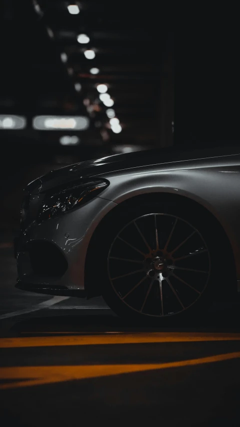 a car parked in a parking garage at night, pexels contest winner, photorealism, detailed alloy wheels, thumbnail, hq 8k cinematic, mercedez benz