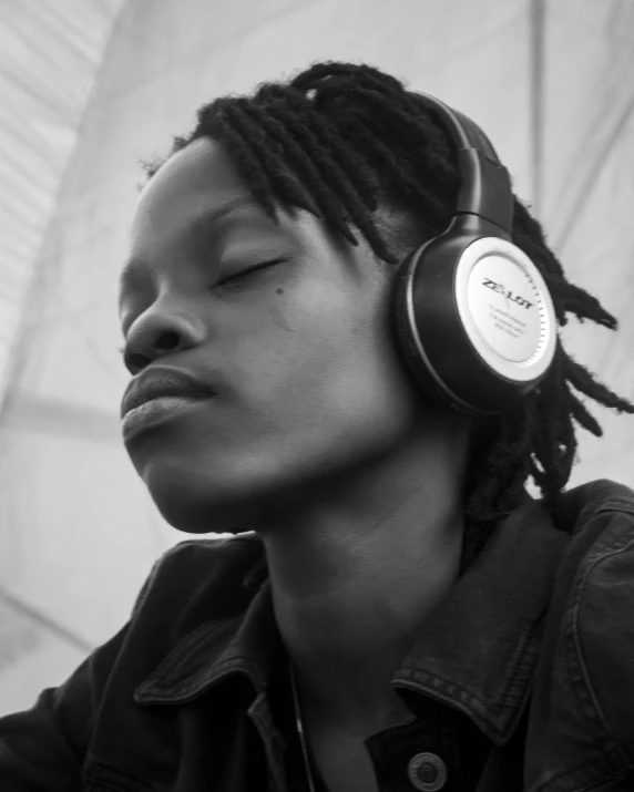 a black and white photo of a man wearing headphones, by Matija Jama, pexels, afrofuturism, black young woman, relaxed expression, androgynous person, avatar for website