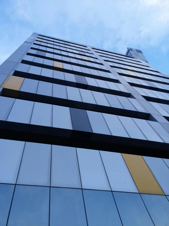 a tall building with a blue sky in the background, black and yellow scheme, vinyl on glazing, thumbnail, melbourne