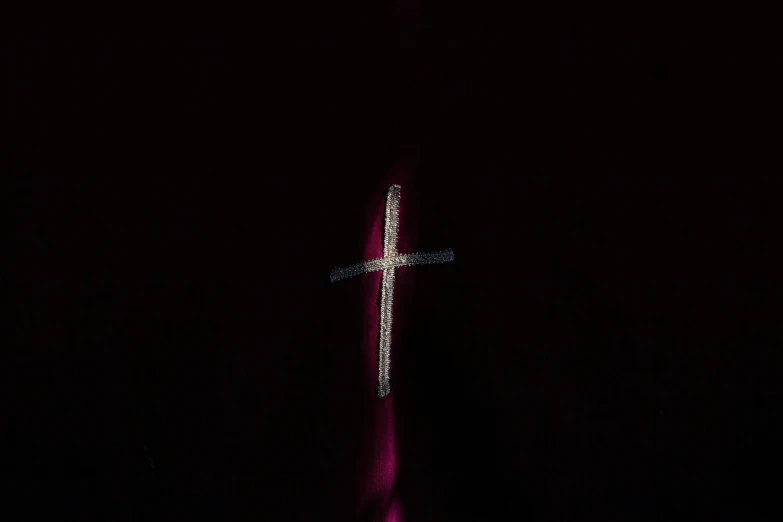 a cross is lit up in the dark, an album cover, by Attila Meszlenyi, unsplash, hurufiyya, yung lean, bedazzled, taken with sony alpha 9, dark red