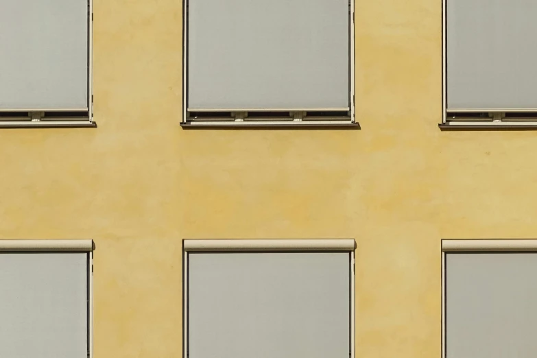 a red fire hydrant sitting in front of a yellow building, a minimalist painting, inspired by Andreas Gursky, unsplash, house windows, light - brown wall, mono-yellow, munich