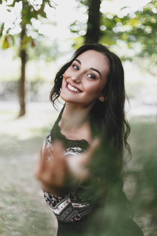 a beautiful young woman holding a frisbee in a park, by Adam Marczyński, pexels contest winner, happily smiling at the camera, headshot profile picture, anna nikonova aka newmilky, young woman with long dark hair