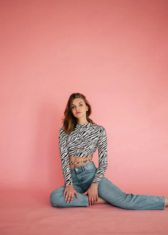 a woman sitting on the ground in front of a pink wall, by Will Ellis, zebra, wearing a cropped top, cute casual streetwear, transparent background