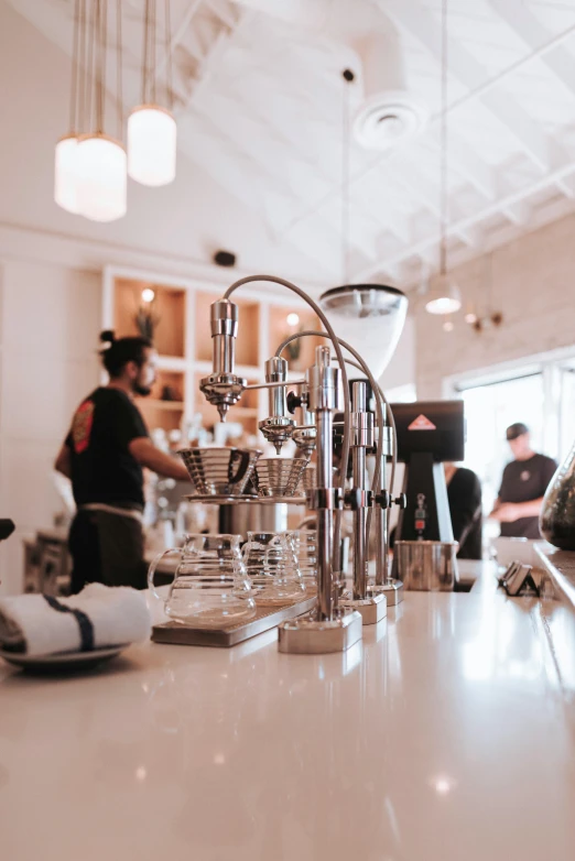 a coffee machine sitting on top of a counter, by Robbie Trevino, pexels contest winner, lots of people, bay area, inside a french cafe, gif