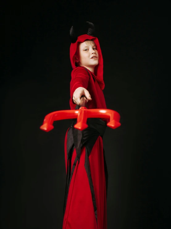 a little boy dressed up in a devil costume, inspired by Jacques Callot, pexels contest winner, hurufiyya, jiang sword, female jedi, high resolution print :1 red, stop motion character