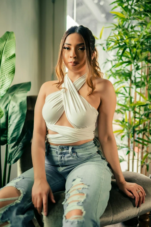 a woman sitting on a bench wearing ripped jeans, a portrait, by Robbie Trevino, renaissance, white halter top, fully covered in drapes, wearing a crop top, asian features