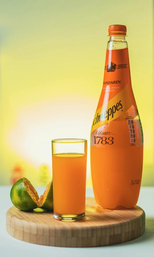 a bottle of orange juice next to a glass of orange juice, a digital rendering, inspired by Jacopo Bellini, pexels, dada, caparisons, product display photograph, mango, 1 8 7 7