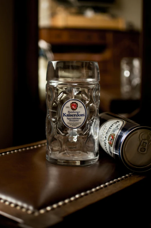 a beer glass sitting on top of a wooden table, large screen, glass jar, mansion, thumbnail