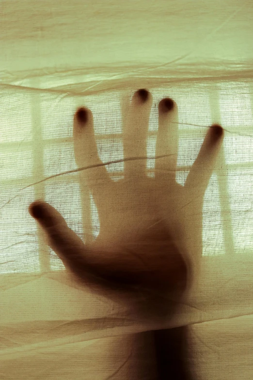 a close up of a person's hand behind a curtain, inspired by Katia Chausheva, frightening, translucent, open palm, istockphoto