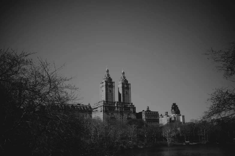 a black and white photo of a city skyline, pexels contest winner, art nouveau, central park, two organic looking towers, detailed medium format photo, an abandoned old