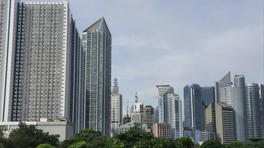 a bunch of tall buildings in a city, a picture, by Robbie Trevino, pexels contest winner, photorealism, manila, side view from afar, various angles, view from front