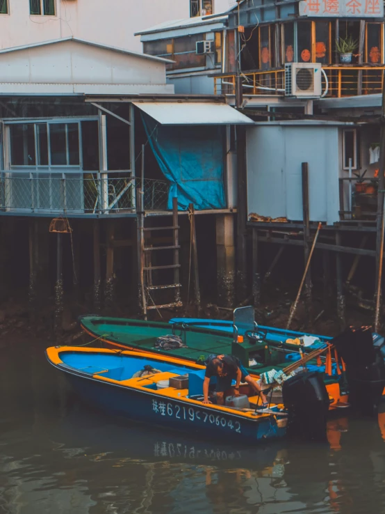 a couple of boats that are in the water, inspired by Elsa Bleda, pexels contest winner, kowloon walled city, exterior photo, fishing, 2 0 2 2 photo