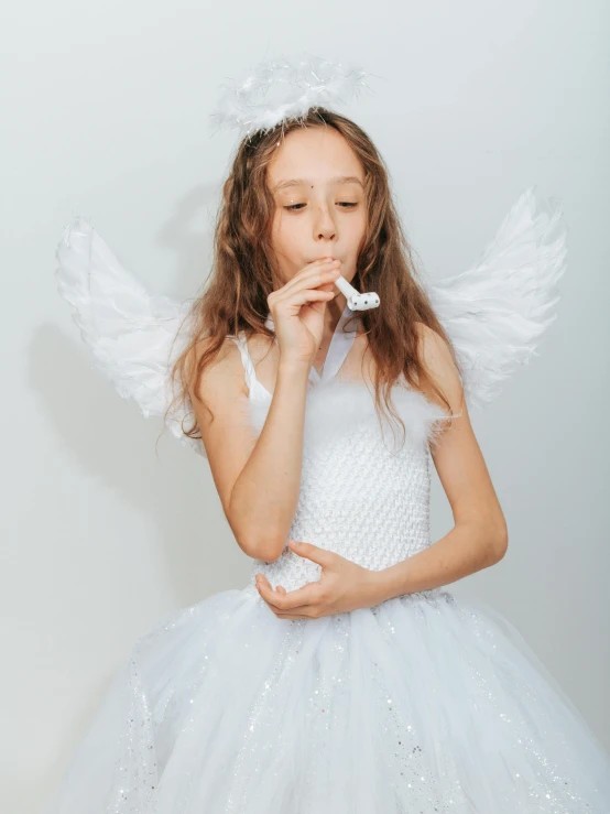 a little girl dressed as an angel blowing bubbles, pexels contest winner, soft devil queen madison beer, on white, authentic costume, teenager