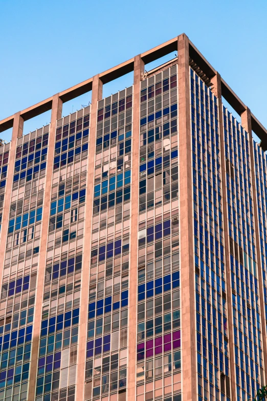 a very tall building with lots of windows, unsplash, brutalism, 1960s color photograph, capital plaza, square lines, hyper - detailed color photo