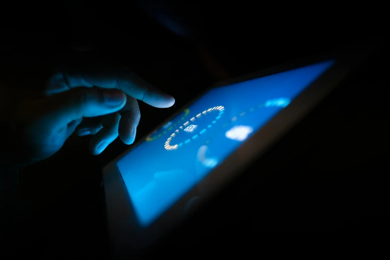 a person using a tablet in the dark, a hologram, tactile buttons and lights, in 2 0 1 5, touching, large screen