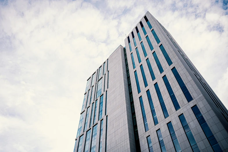 a very tall building with lots of windows, inspired by Tadao Ando, unsplash, coventry city centre, grey, office, uhq