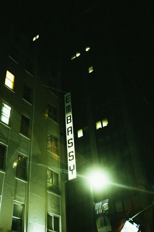 a tall building is lit up at night, an album cover, inspired by Brassaï, unsplash, bauhaus, ecstasy, official store photo, 2 0 0 2 photo, subspace emissary