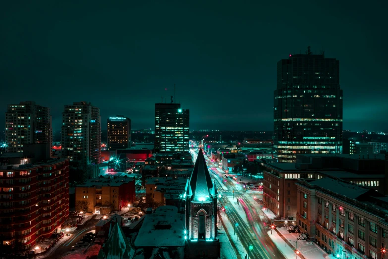 an aerial view of a city at night, a colorized photo, by Andrew Domachowski, unsplash contest winner, winnipeg skyline, coventry city centre, teal aesthetic, quebec