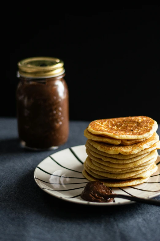 a stack of pancakes sitting on top of a plate, a portrait, unsplash, chocolate frosting, jars, square, 0