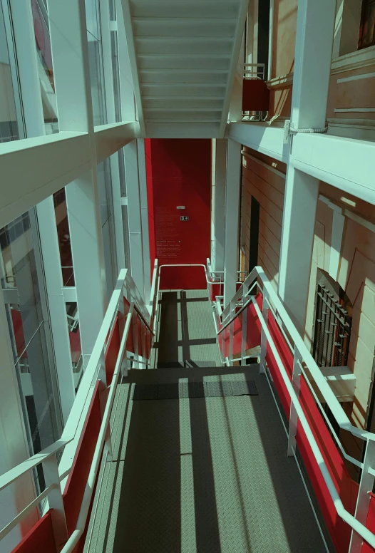 a red door and some stairs in a building, inspired by Richard Estes, modernism, nvidia raytracing demo), photograph from above, 1999 photograph, color footage