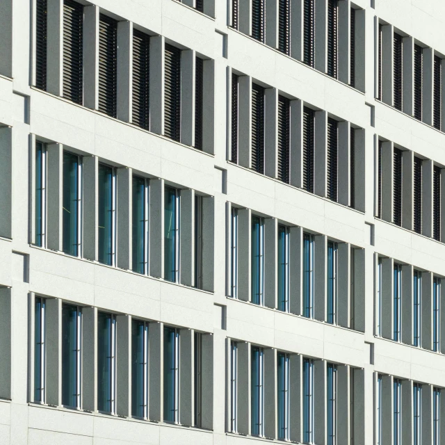 a large white building with lots of windows, inspired by David Chipperfield, unsplash, bauhaus, cyan shutters on windows, detail texture, concrete steel glass, munich