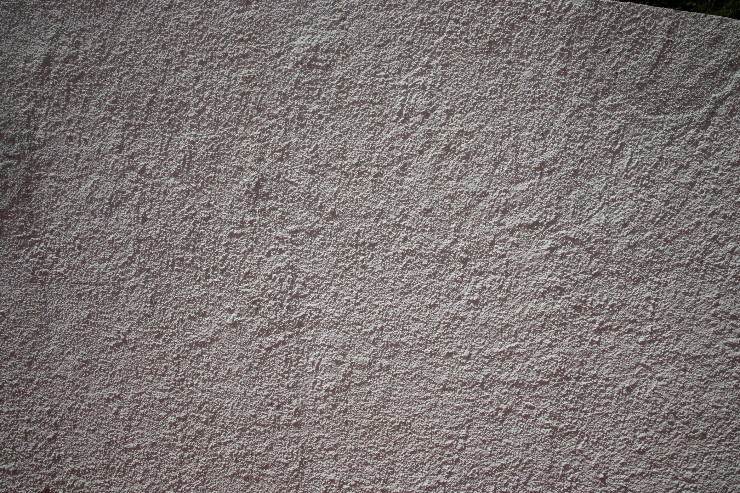 a red fire hydrant sitting on top of a cement wall, a stipple, inspired by Agnes Martin, unsplash, taupe, floor texture, light grey, 16mm grain