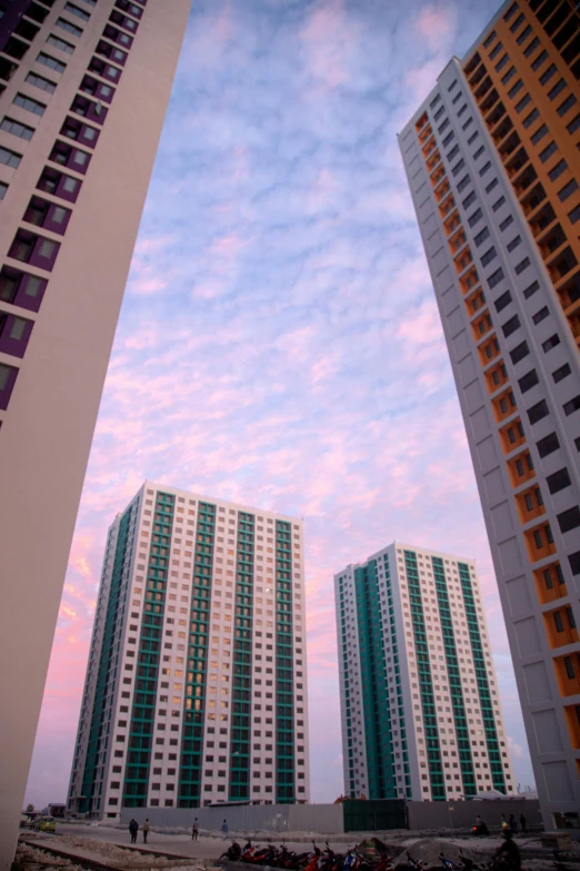 a couple of tall buildings sitting next to each other, unsplash, hyperrealism, pastel sky, zezhou chen, mass housing, flat