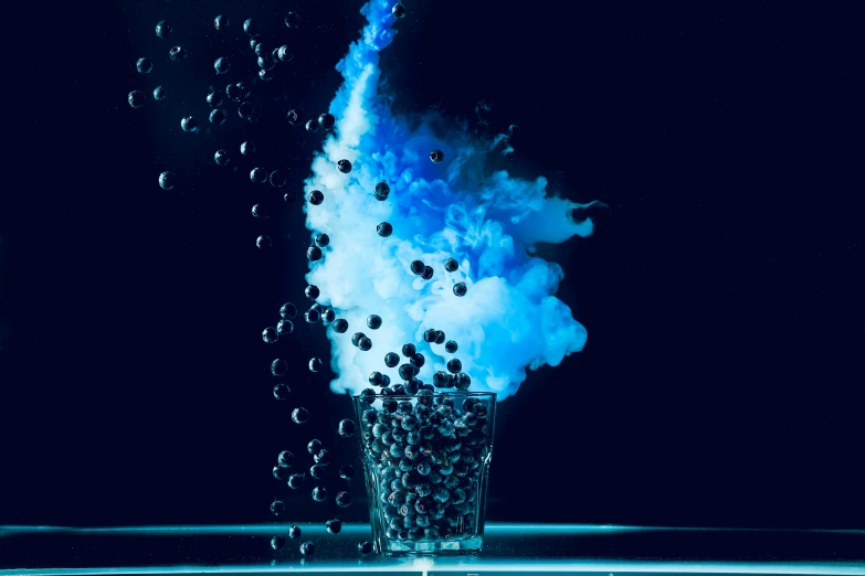 a glass filled with bubbles sitting on top of a table, digital art, inspired by Otto Piene, pexels, art photography, bright blue smoke, “berries, smokey cannons, black and blue