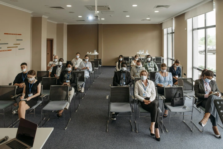 a group of people sitting in chairs in a room, masks, ukraine. professional photo, profile image, thumbnail