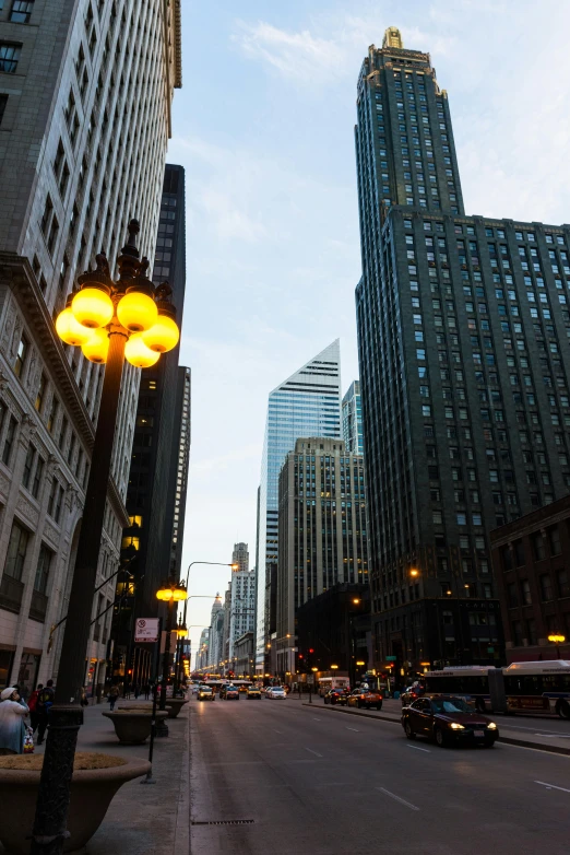 a city street filled with lots of tall buildings, street lighting, mies van der rohe, uncropped, chicago