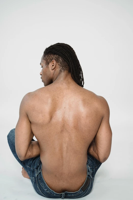 a man sitting on the ground with his back to the camera, inspired by Terrell James, hair gel combed backwards, ( ( dark skin ) ), clear background, big symmetrical scar features