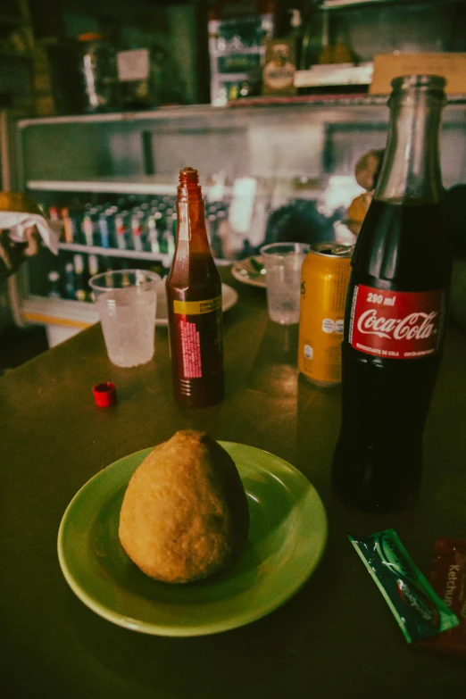 a close up of a plate of food on a table, by Elsa Bleda, drinking a bottle of coca-cola, cuban setting, nugget, photo taken on fujifilm superia