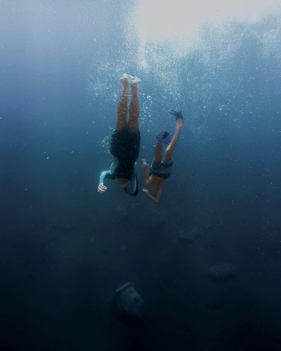 a person swimming in a body of water, by Jessie Algie, unsplash contest winner, sumatraism, lesbians, scuba diving, ignant, falling