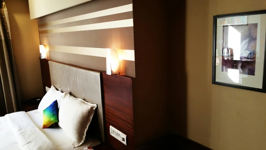 a bed room with a neatly made bed and a picture on the wall, by Matija Jama, brown and cream color scheme, lines of lights, pristine quality wallpaper, handmade