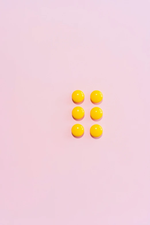 yellow pills on a pink background, by Justin Sweet, visual art, top down shot, square shapes, minimalist photo, dots