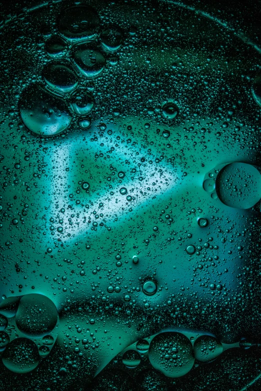 a close up of water droplets on a glass, an album cover, inspired by Elsa Bleda, teal-neon viking runes, in triangular formation, molecular gastronomy, square