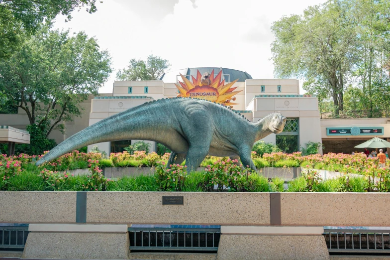 a statue of a dinosaur in front of a building, with lots of vegetation, spinosaurus, fan favorite, tar pits