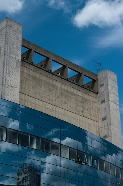 a clock that is on the side of a building, brutalism, blue sky above, neo - andean architecture, pictured from the shoulders up, hoog detail