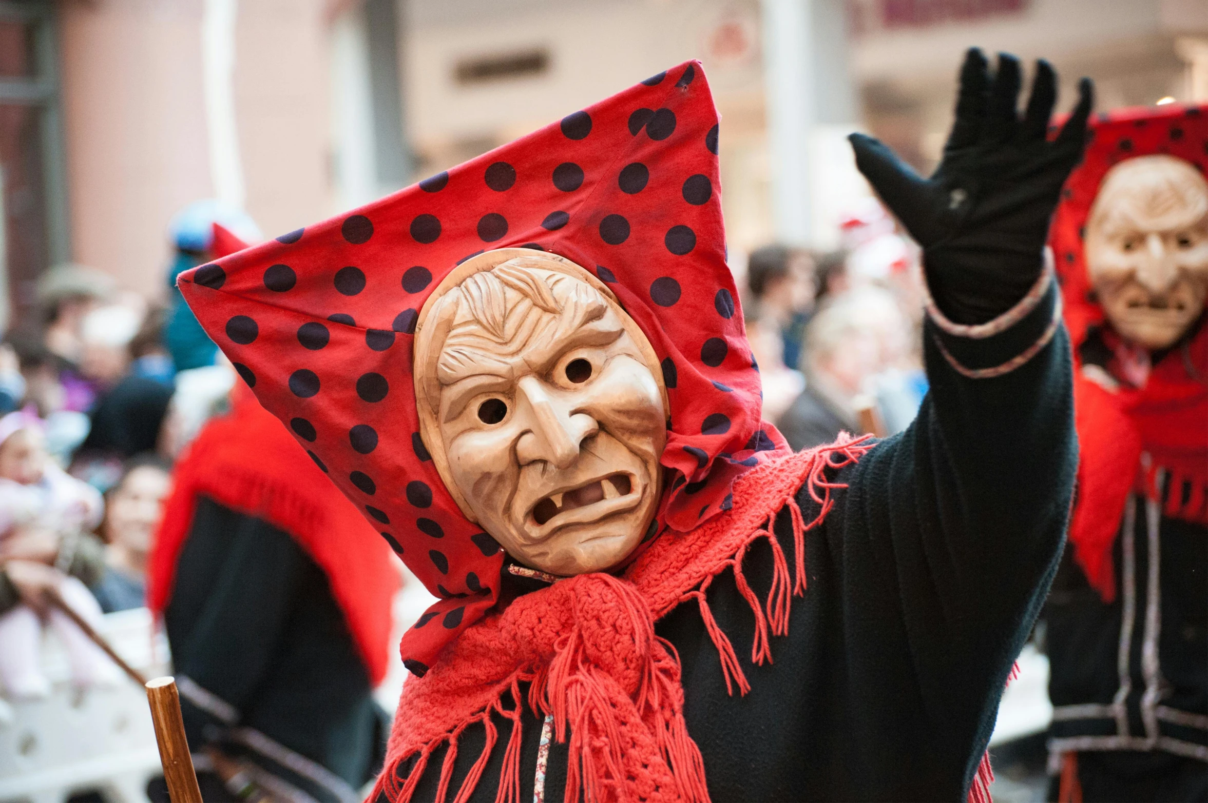 a group of people wearing masks and scarves, a photo, pexels contest winner, antipodeans, portrait of a red sorcerer, wearing wooden mask, black pulcinella mask, over-shoulder shot