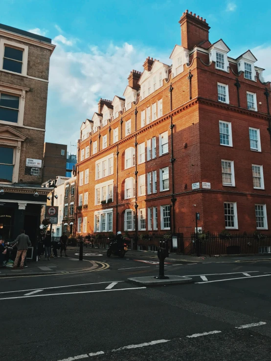 a tall red brick building sitting on the side of a road, pexels contest winner, 1 9 th century london, 😭 🤮 💕 🎀, brown, street elevation