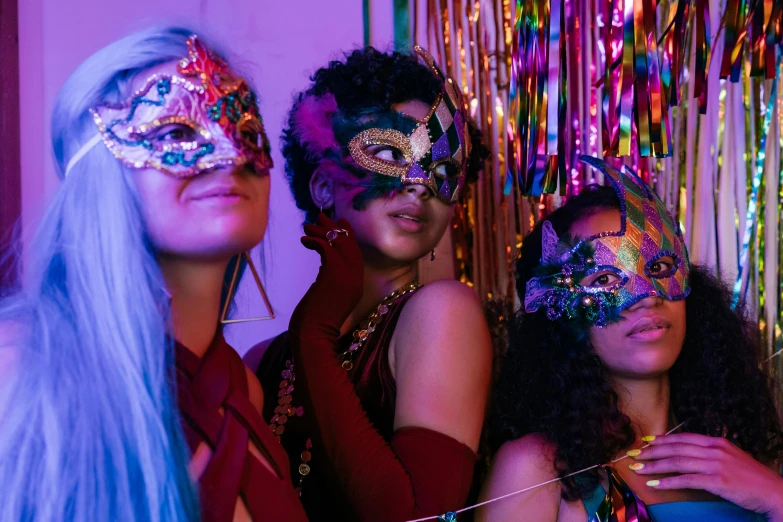 a group of women standing next to each other, trending on pexels, maximalism, elaborate lights. mask on face, college party, iridescence, three women