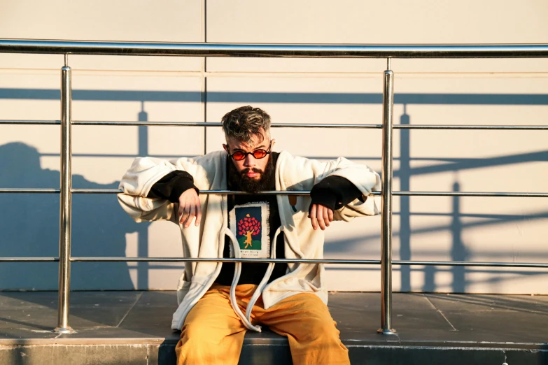 a man that is sitting down on some steps, an album cover, inspired by Karl Gerstner, unsplash, renaissance, bad bunny, blocking the sun, icon, press shot