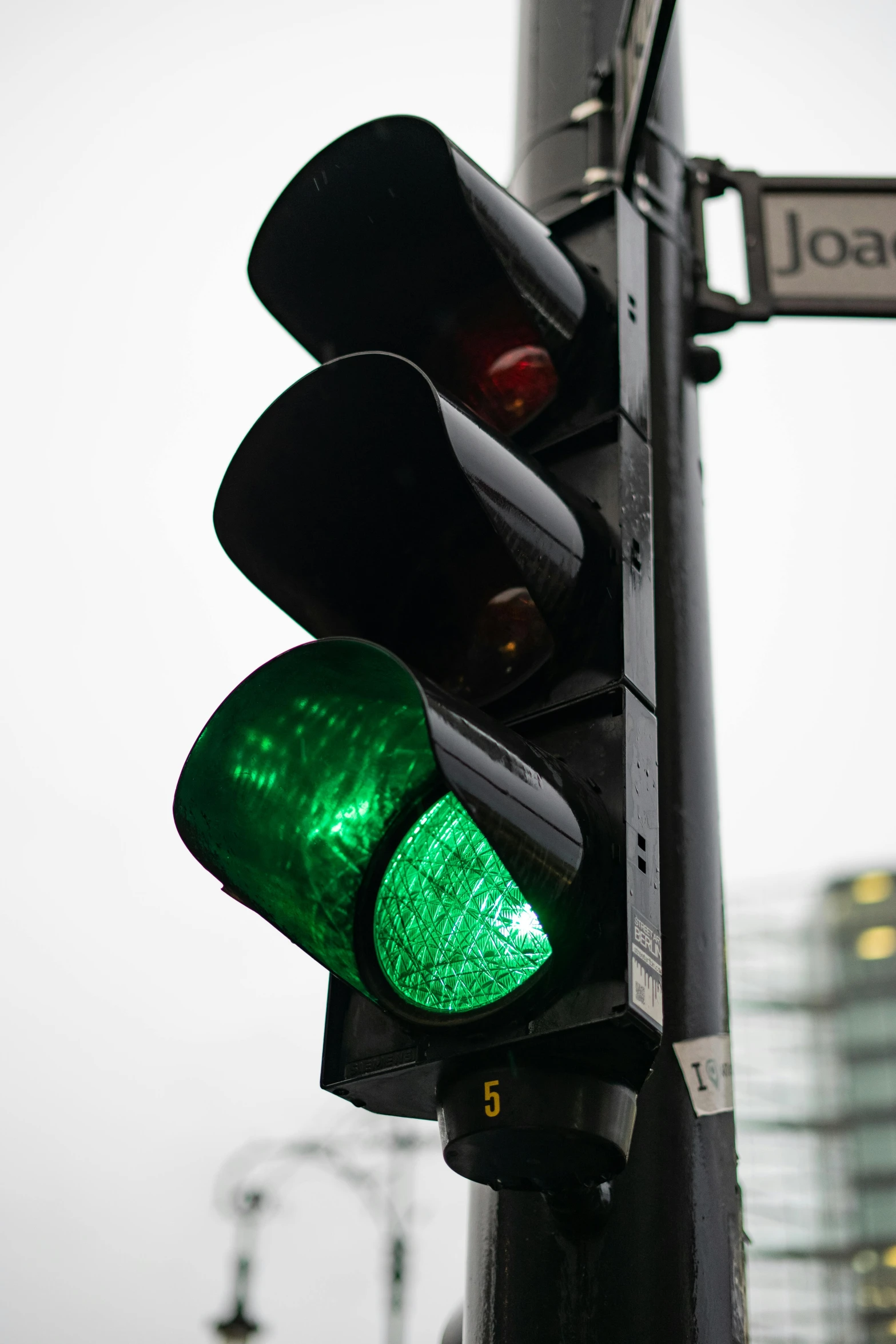 a close up of a traffic light on a pole, black and green scheme, jenna barton, compassionate, 🚿🗝📝