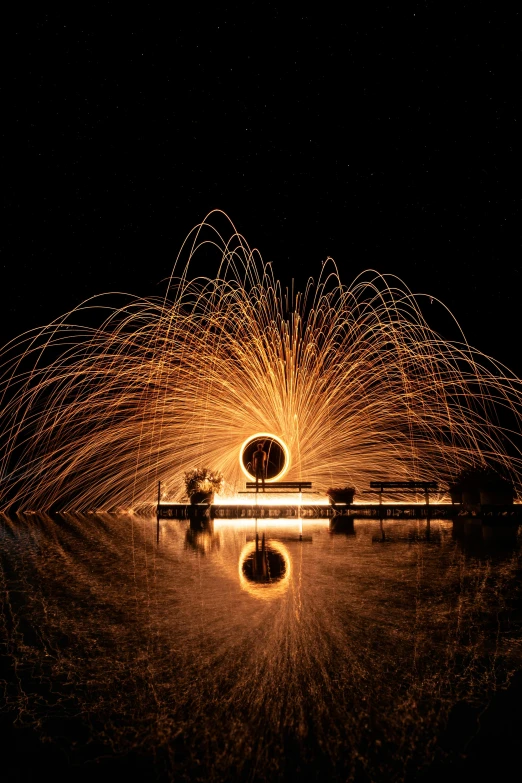 a fire spinning in the air over a body of water, a stipple, pexels contest winner, kinetic art, with sparking circuits, award winning image, having a good time, reflecting