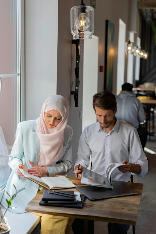 a couple of people that are sitting at a table, by Daren Bader, hurufiyya, coworkers, white hijab, elegant study, customers