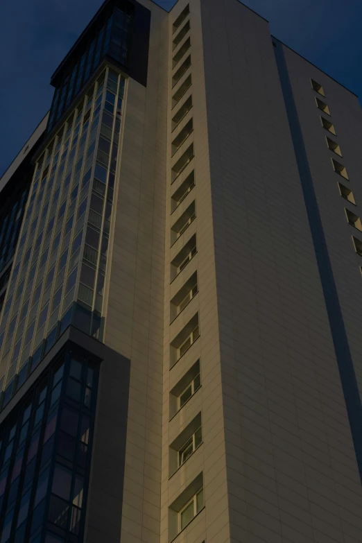 a tall building with a clock on the top of it, by Sengai, backlit!!, hotel room, late summer evening, front side